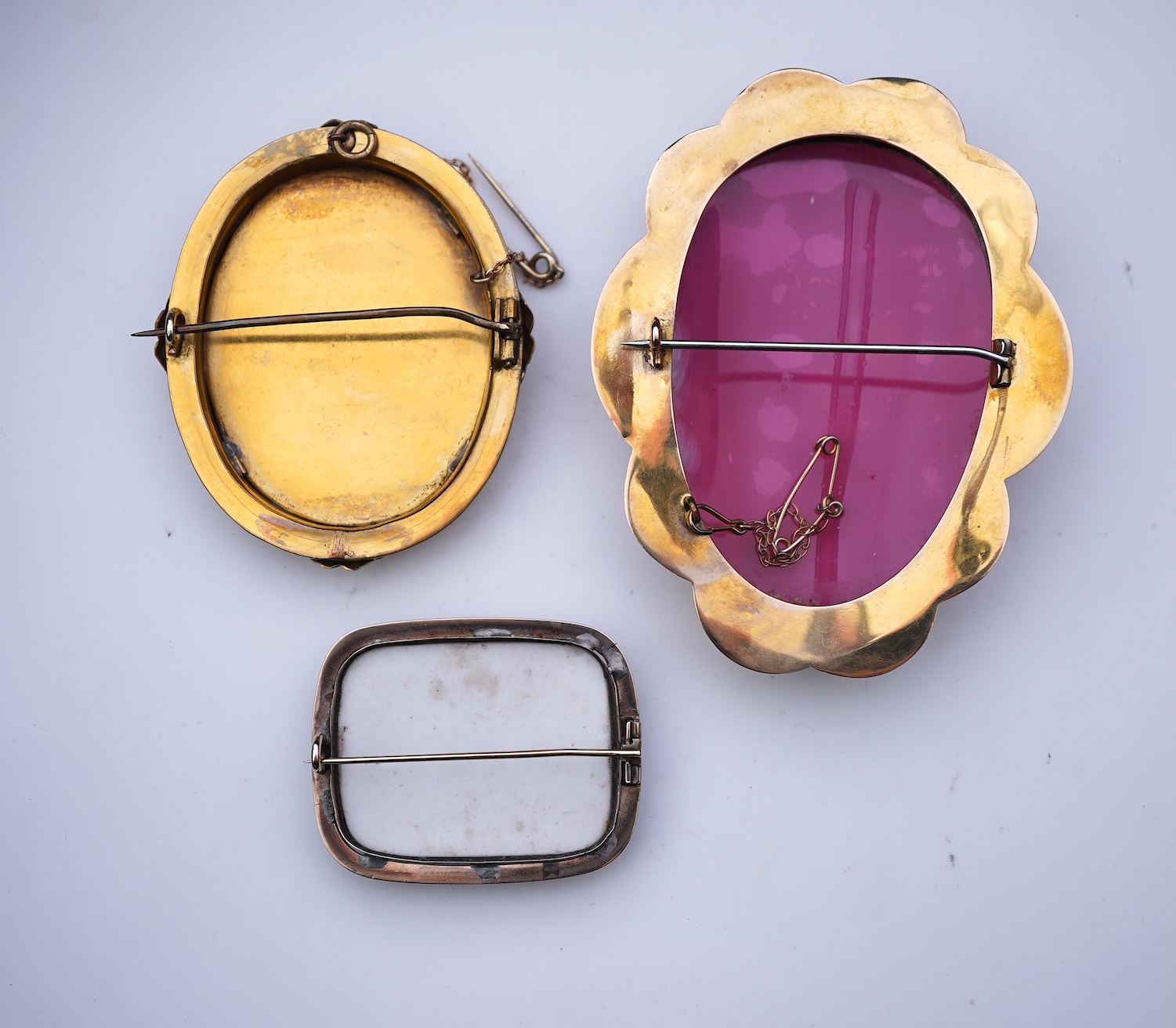 Three painted enamel brooches, mid 19th century